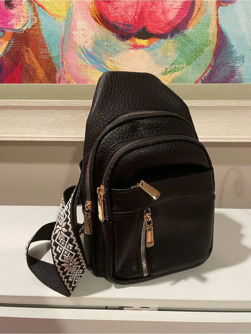 Black ‘Leather’ Sling Backpack with Patterned Strap